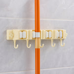 Close-up image of broom holder's multi-roller grip system on wall