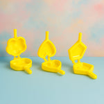 Plastic cookie cutters arranged on kitchen counter for biscuit making