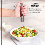 Two thumb press grinders, one for salt and one for pepper, on a table.