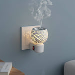 Star cut glass aroma diffuser plugged into electrical wall socket