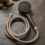 Flexible stainless steel shower hose attached to handheld shower head