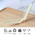 Close-up of comb teeth and brush bristles on foldable tool