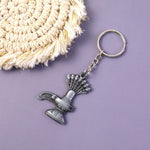 Close-up view of metal Shiva Lingam and Naag symbol on keychain