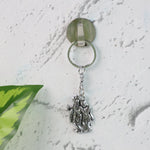 Radha Krishna metal keychain displayed on white background