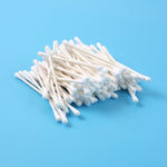 Close-up of cotton swabs highlighting paper stick stems for grooming