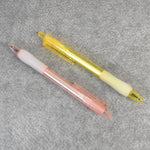 A pair of CustoPen ballpoint pens displayed with essential office stationery.