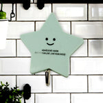 A set of strong self-adhesive hooks displayed neatly on a tiled kitchen wall, ready for use.