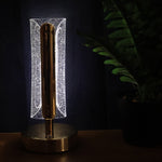 Golden crystal table lamp glowing warmly in living room decor