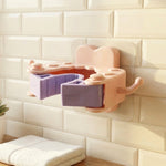 Installation of wall mounted holder clip demonstrated with adhesive