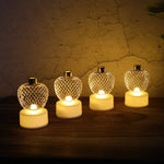 Apple LED tealight candles arranged on a festive backdrop for Diwali decor.