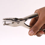 Detailed view of the single hole puncher's spring mechanism for smooth operation.