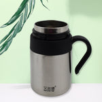 Person holding the Bottlart vacuum insulated mug with its ergonomic handle.