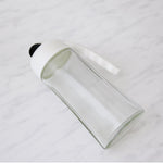 Automatic lid mechanism opening on glass oil bottle dispenser