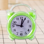 Close-up of quartz alarm clock white dial with bold black numerals