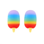 Child's hand holding a mini popsicle eraser, showing its compact size.