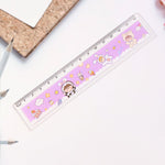 Children using cartoon-themed plastic ruler for drawing and geometry