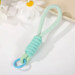 Various uses of the multipurpose strap, including attaching to keys and a camera, showcasing versatility.