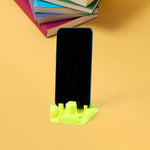 Hexagonal plastic mobile phone stand holding smartphone securely