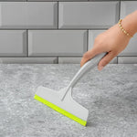 Kitchen wiper effectively cleaning a glass surface, leaving it spotless.