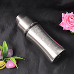 BPA-free stainless steel milk bottle by Ganesh, showing measurements and hygienic cover.