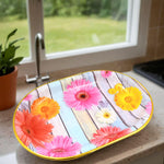 Stylish plastic serving tray with a vibrant floral pattern on a kitchen counter.