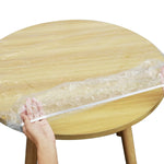 Side view showing the seamless fit of the elastic table protector on a table.