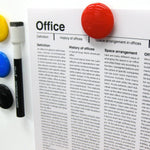 Three translucent yellow circular magnetic buttons arranged