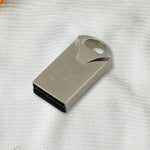 USB Car Bluetooth Adapter next to a smartphone, illustrating wireless connectivity.
