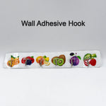 Versatile transparent adhesive hook holding kitchen utensils on a wall.