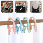 Space-saving foldable travel hanger designed to keep clothes wrinkle-free