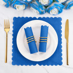 Two royal blue scalloped napkins, one open, showcasing size and texture