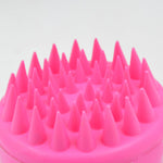 Scalp cleansing brush with ergonomic handle for deep hair wash.