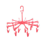 Close-up of the clothes clips hanger securely holding baby clothes for quick drying.