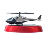 Solar helicopter air freshener positioned inside car interior