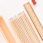 The wooden ruler and the colorful pencil box, essential accessories from the art kit.