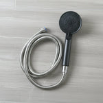 Flexible stainless steel hose connected to shower handle