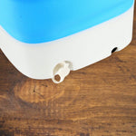Portable washing machine with a clear view of its interior capacity for small loads.