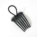 Hair styling comb clip securing hair in a voluminous bun style