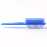 Person using dual-action foot scrubber and pumice stone to exfoliate heel