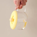 A transparent Silicone Cup Lid covering a glass cup, illustrating its universal fit.