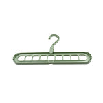 Organized wardrobe interior with multi-hole plastic hangers maximizing storage space.