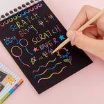 Multiple rainbow art scratch books stacked, emphasizing the pack of 10 pages.