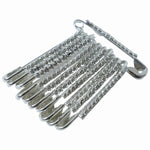 Multiple silver safety pins from the 12-piece decorative brooch set