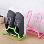 Space-saving drying shelf with integrated shoe and hanger stand, perfect for small apartments.