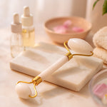 Hand holding the facial massage roller with two stone heads for gentle self-care.