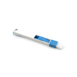 The compact cleaning brush efficiently removing dust and dirt from a window groove.