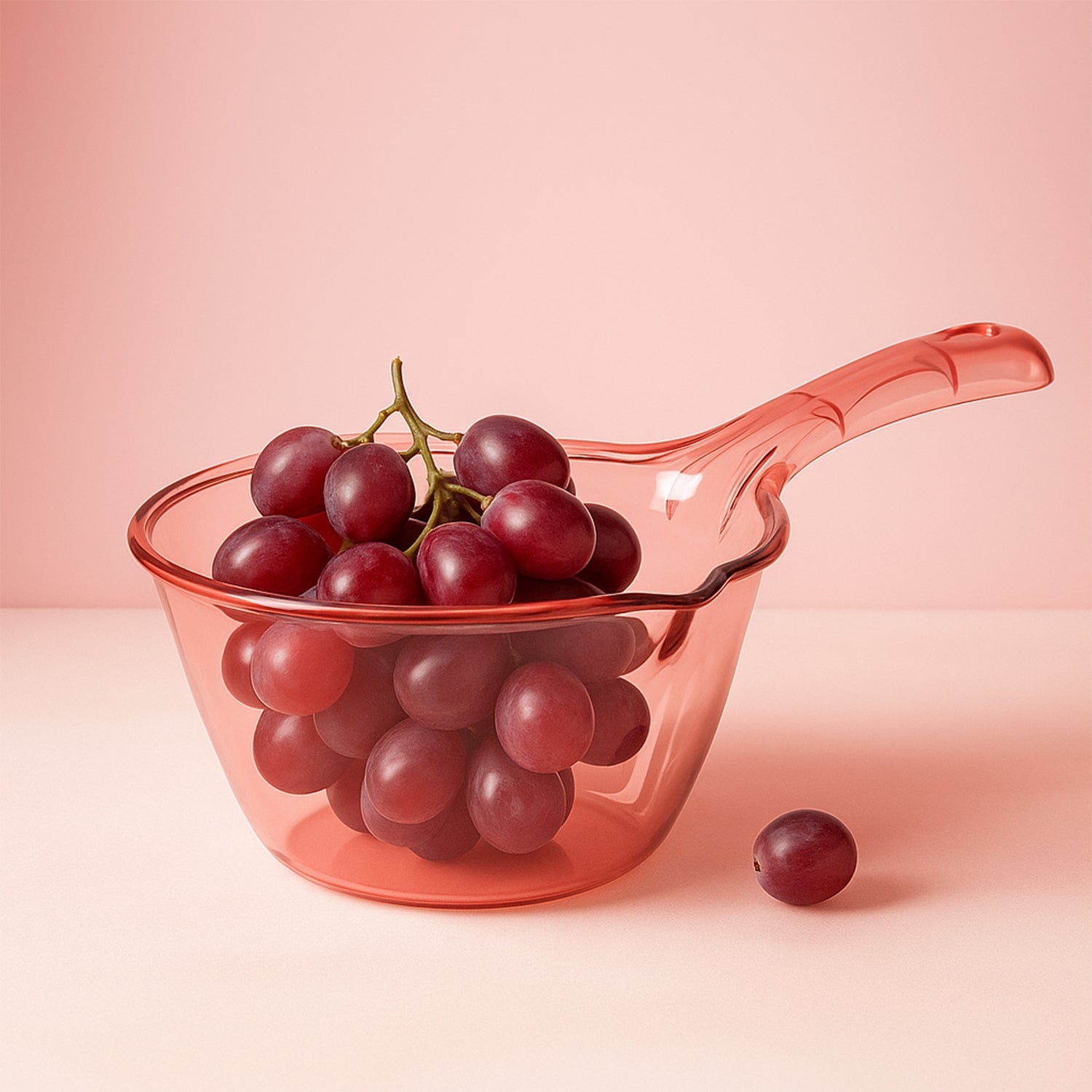 Close-up of ergonomic handle and spout on kitchen washing and straining bowl