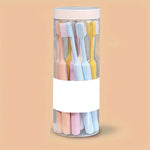 An individual soft plastic toothbrush from the set, featuring an ergonomic handle and soft bristles.