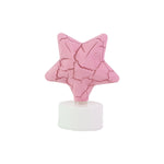 Group of flameless star shaped LED tealight candles shining softly