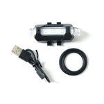 Multipurpose LED bicycle safety light attached easily, demonstrating versatile mounting.